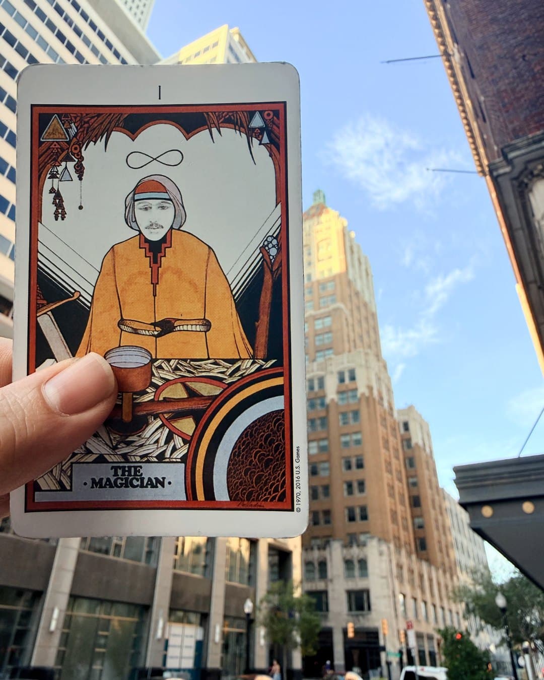 The Magician from the Aquarian Tarot, held up in front of the Philtower on Boston Avenue